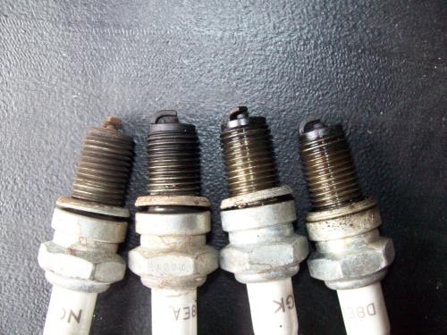 The far left spark plug was dry and brown looking compared to the others.
